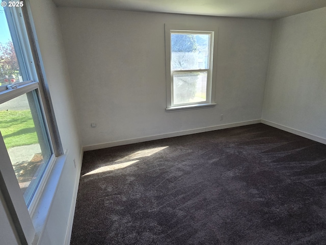 3208 W 7th St, The Dalles, OR 97058 - spare room featuring dark carpet, baseboards, and a healthy amount of sunlight