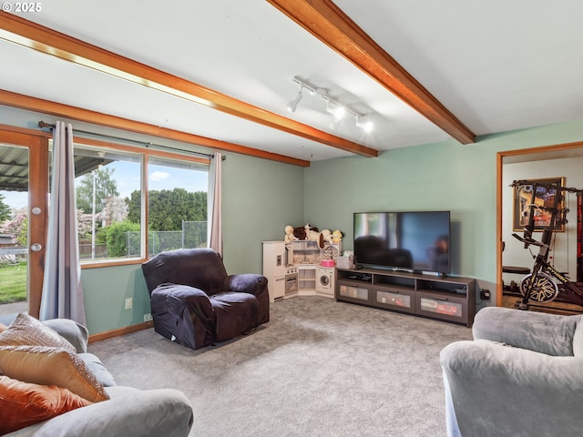 carpeted living room with beamed ceiling
