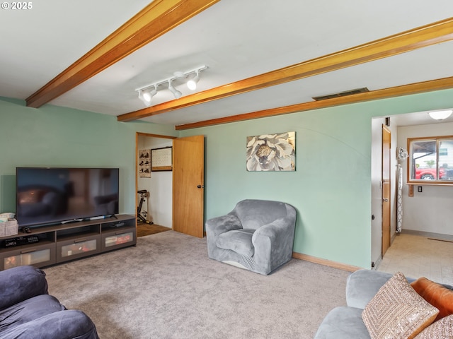 carpeted living area featuring beamed ceiling and visible vents