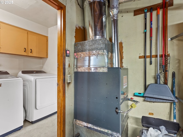 clothes washing area featuring cabinet space and separate washer and dryer