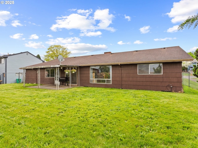 back of house featuring a patio and a lawn