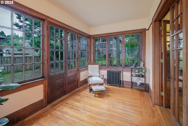 1343 Jerome Ave, Astoria, OR 97103 - sunroom featuring radiator heating unit, wood finished floors, and french doors