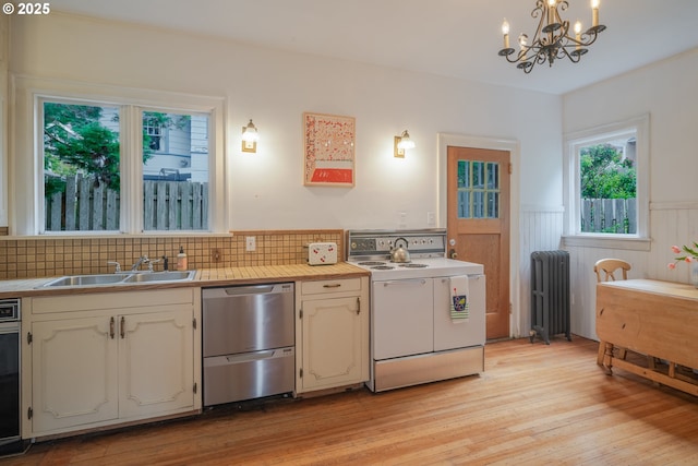 1343 Jerome Ave, Astoria, OR 97103 - kitchen featuring white electric stove, dishwasher, radiator heating unit, a chandelier, and a wainscoted wall