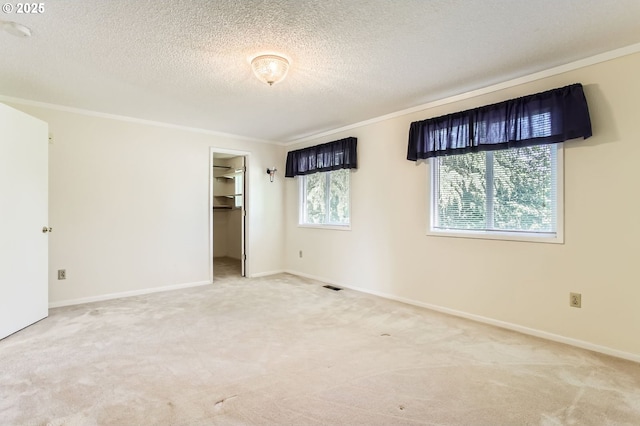 220 NE Village Squire Ave, Gresham, OR 97030 - unfurnished bedroom featuring carpet, crown molding, a textured ceiling, a spacious closet, and baseboards