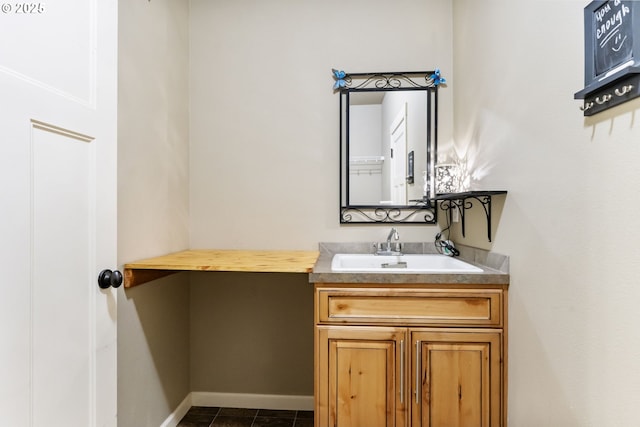 bathroom featuring vanity, baseboards, and tile patterned flooring