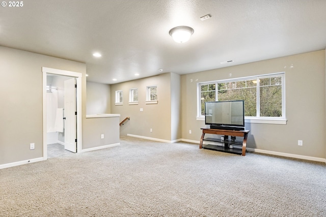 unfurnished living room with recessed lighting, baseboards, carpet, and a textured ceiling