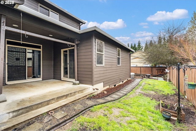 back of property with a patio and a fenced backyard