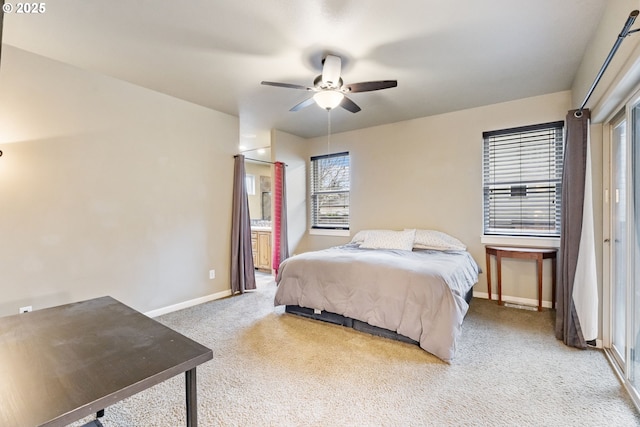 carpeted bedroom with connected bathroom, baseboards, and ceiling fan