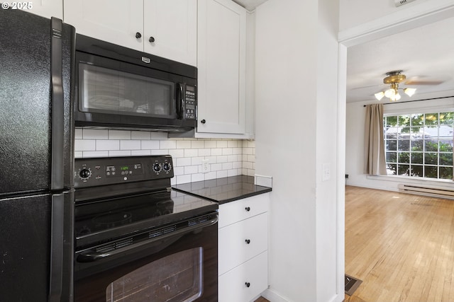 2000 Harney St, Vancouver, WA 98660 - kitchen with black appliances, tasteful backsplash, white cabinetry, wood finished floors, and dark countertops