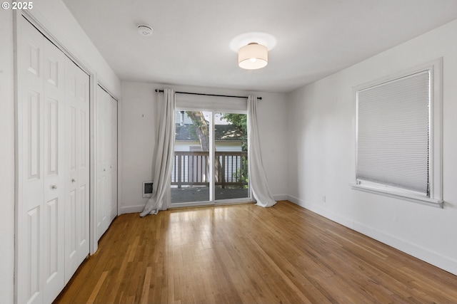 2000 Harney St, Vancouver, WA 98660 - unfurnished bedroom featuring access to outside, wood finished floors, and multiple closets