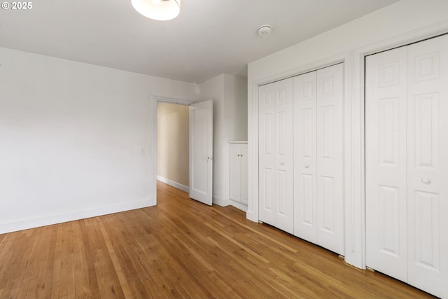 2000 Harney St, Vancouver, WA 98660 - unfurnished bedroom with wood finished floors and two closets