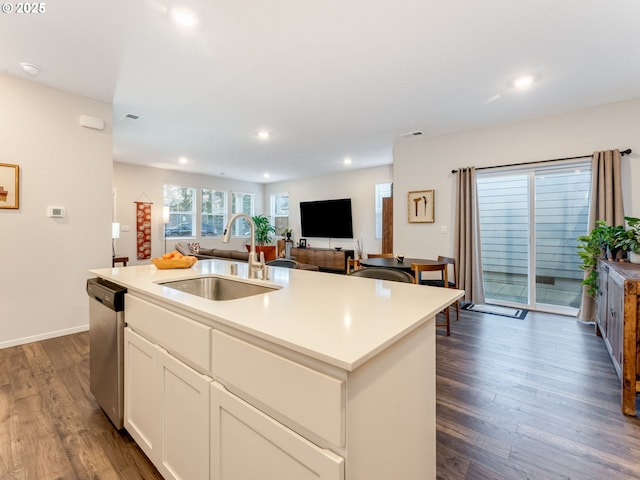 kitchen featuring dishwasher, an island with sink, sink, white cabinetry, and dark wood-type flooring