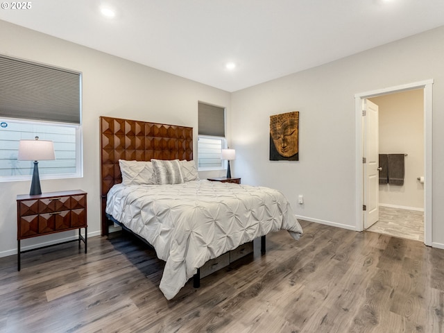 bedroom with hardwood / wood-style flooring and connected bathroom