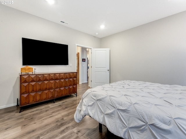 bedroom with wood-type flooring