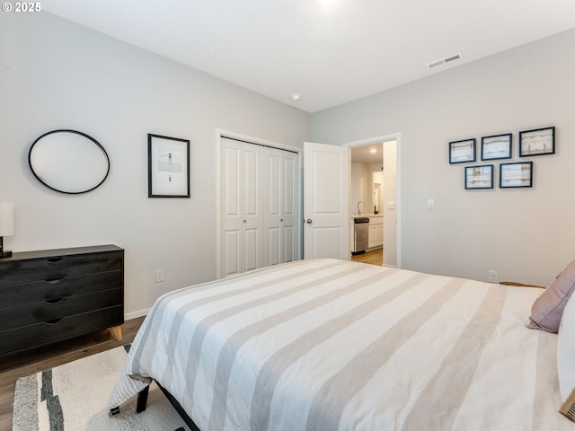 bedroom with hardwood / wood-style flooring and a closet