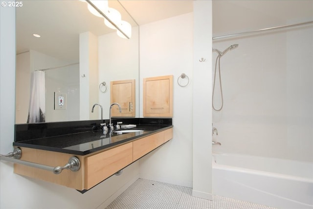 bathroom with tile patterned floors, shower / bath combo with shower curtain, and vanity