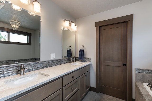 34800 Westboro Way, Saint Helens, OR 97051 - full bathroom featuring double vanity, tiled tub, tile patterned floors, and a textured ceiling