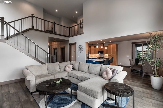 34800 Westboro Way, Saint Helens, OR 97051 - living area featuring wood finished floors, baseboards, stairs, a towering ceiling, and recessed lighting