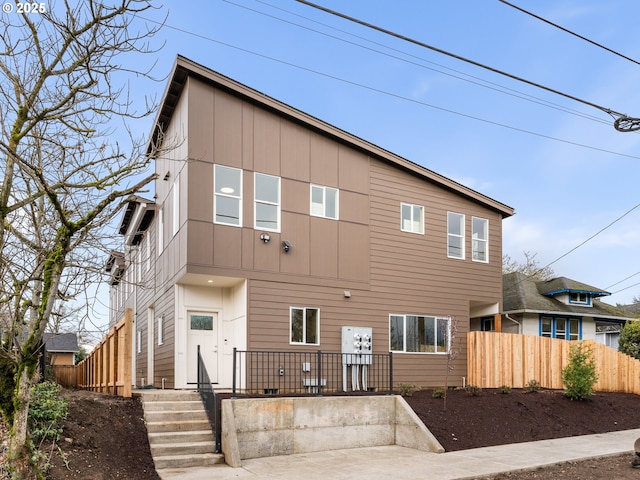 rear view of property with fence