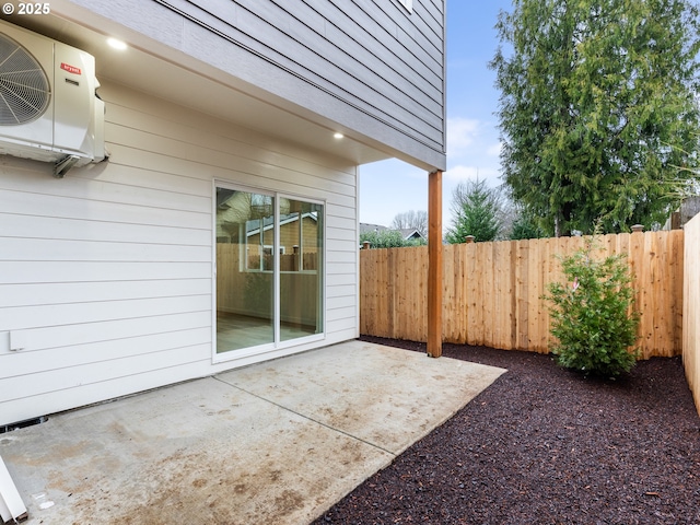 view of patio / terrace featuring ac unit and fence