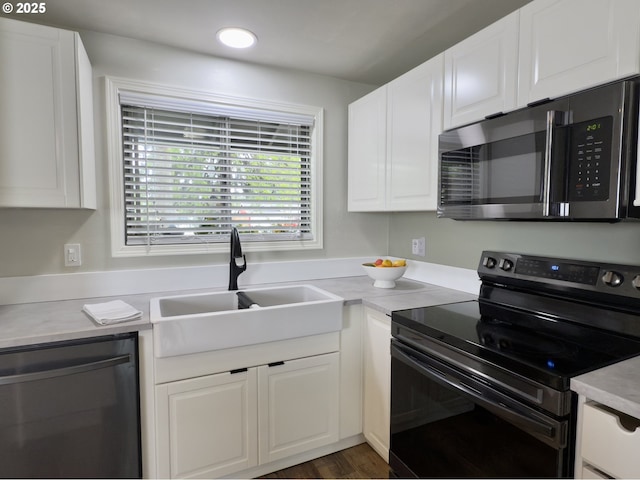 19795 SW Frances St, Beaverton, OR 97003 - kitchen with electric range, dishwashing machine, stainless steel microwave, a sink, and white cabinets