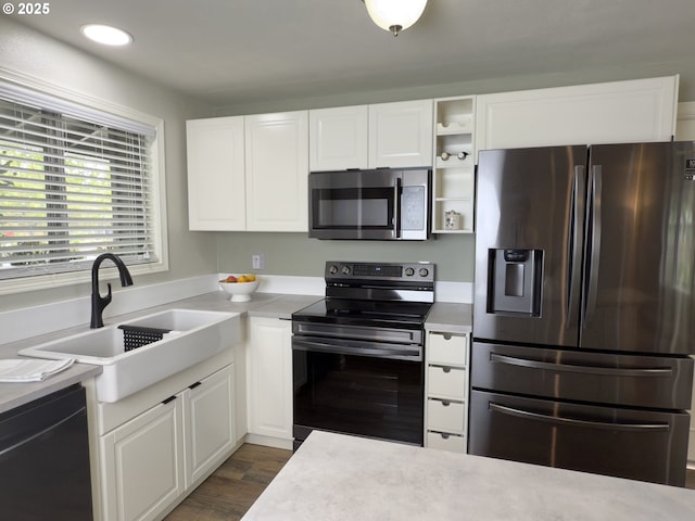 19795 SW Frances St, Beaverton, OR 97003 - kitchen with appliances with stainless steel finishes, a sink, white cabinetry, light countertops, and recessed lighting