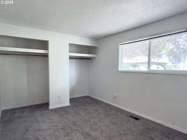 19795 SW Frances St, Beaverton, OR 97003 - unfurnished bedroom featuring multiple closets, dark colored carpet, a textured ceiling, and baseboards