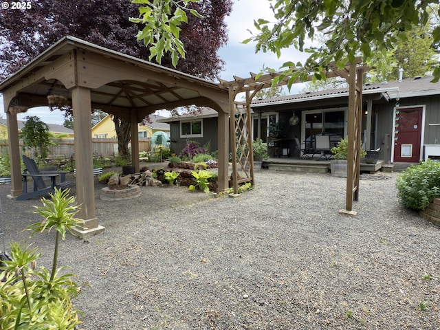 19795 SW Frances St, Beaverton, OR 97003 - rear view of house with fence, a gazebo, a patio, and an outdoor fire pit