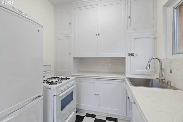 kitchen with sink, white cabinets, tasteful backsplash, white appliances, and tile countertops