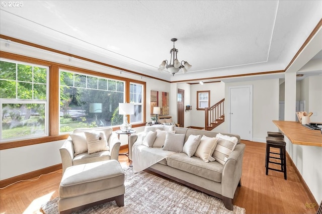 3700 NE Maywood Pl, Portland, OR 97220 - living room with a chandelier, light wood-type flooring, baseboards, and stairway