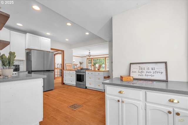 3700 NE Maywood Pl, Portland, OR 97220 - kitchen featuring stainless steel appliances, white cabinetry, tasteful backsplash, light wood-type flooring, and recessed lighting
