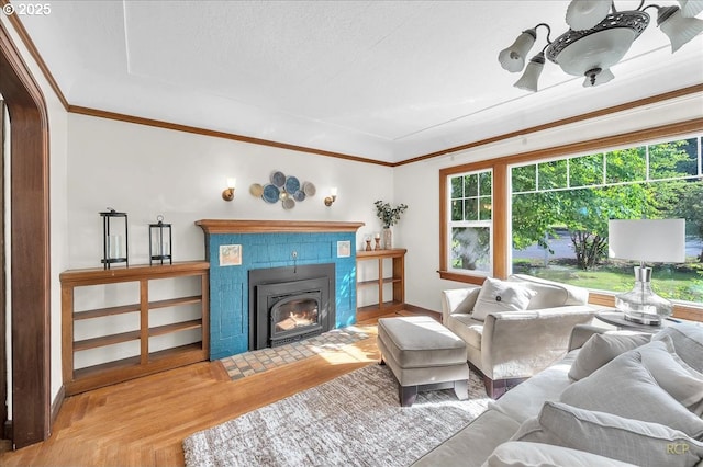 3700 NE Maywood Pl, Portland, OR 97220 - living room featuring crown molding, a tiled fireplace, and wood finished floors