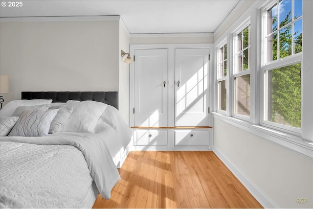 3700 NE Maywood Pl, Portland, OR 97220 - bedroom featuring light wood-type flooring, ornamental molding, and baseboards