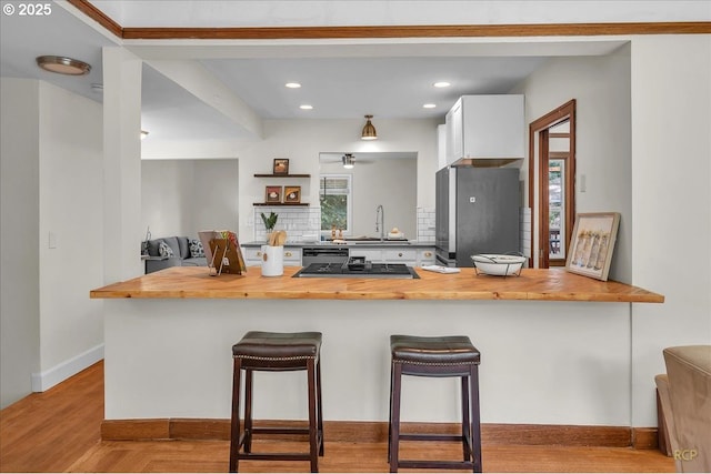 3700 NE Maywood Pl, Portland, OR 97220 - kitchen featuring wood counters, freestanding refrigerator, gas cooktop, wood finished floors, and a peninsula