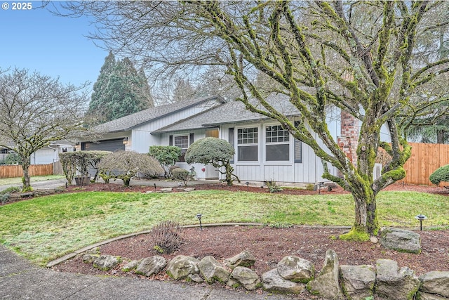 view of front of property with a garage and a front yard