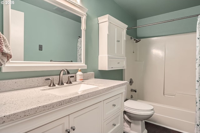 full bathroom featuring toilet, shower / bath combination with curtain, and vanity