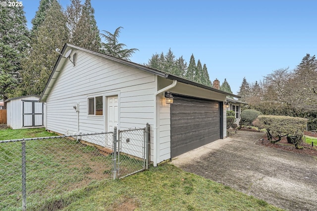 view of home's exterior featuring a storage unit, a lawn, and a garage