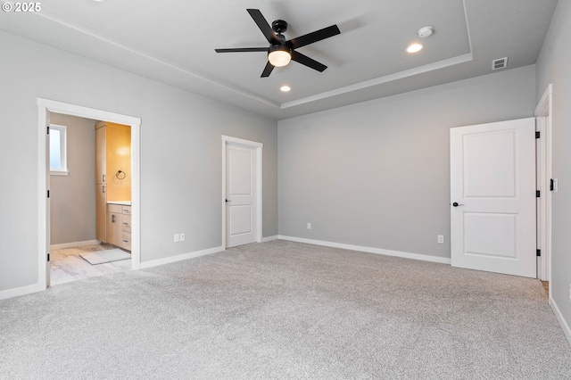 5807 NE 77th Cir, Vancouver, WA 98661 - unfurnished bedroom featuring recessed lighting, light carpet, a raised ceiling, ensuite bathroom, and a ceiling fan