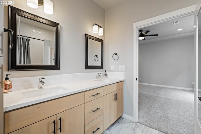 5807 NE 77th Cir, Vancouver, WA 98661 - bathroom featuring double vanity, ceiling fan, and marble look tiles