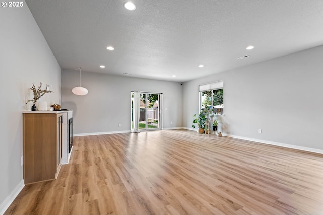 5807 NE 77th Cir, Vancouver, WA 98661 - unfurnished living room with light wood finished floors, recessed lighting, and a textured ceiling