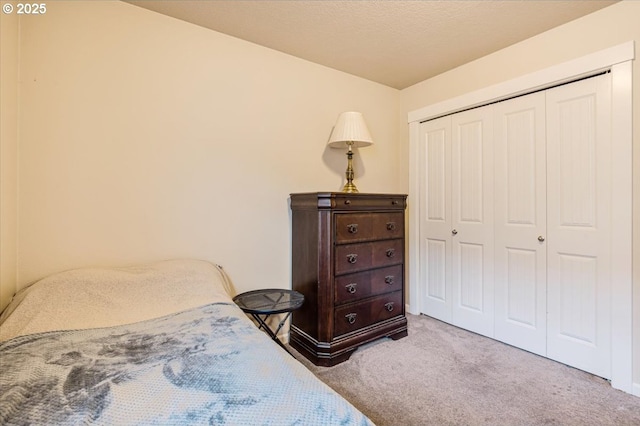 bedroom featuring light carpet and a closet