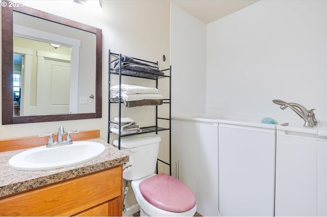 bathroom featuring toilet and vanity