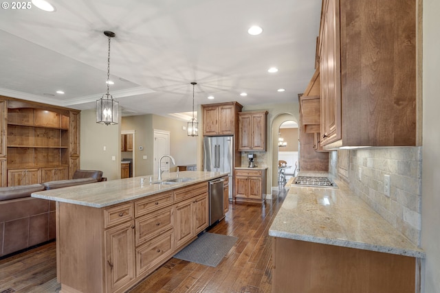 4506 NE 121st St, Vancouver, WA 98686 - kitchen featuring arched walkways, stainless steel appliances, dark wood finished floors, a sink, and light stone countertops