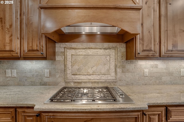 4506 NE 121st St, Vancouver, WA 98686 - kitchen featuring stainless steel gas cooktop, arched walkways, backsplash, and brown cabinetry