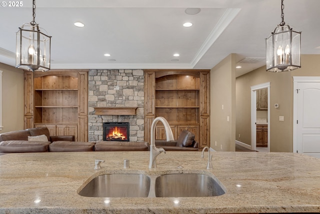 4506 NE 121st St, Vancouver, WA 98686 - kitchen featuring a sink, open floor plan, ornamental molding, hanging light fixtures, and light stone countertops