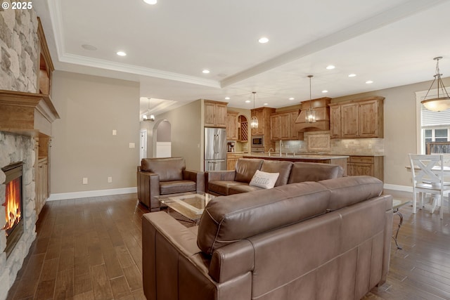 4506 NE 121st St, Vancouver, WA 98686 - living area with arched walkways, baseboards, dark wood-style floors, a tray ceiling, and recessed lighting