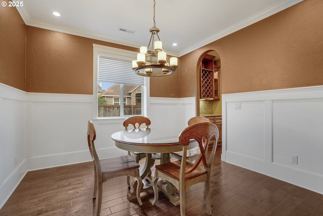 4506 NE 121st St, Vancouver, WA 98686 - dining room with a decorative wall, a wainscoted wall, a chandelier, dark wood finished floors, and ornamental molding