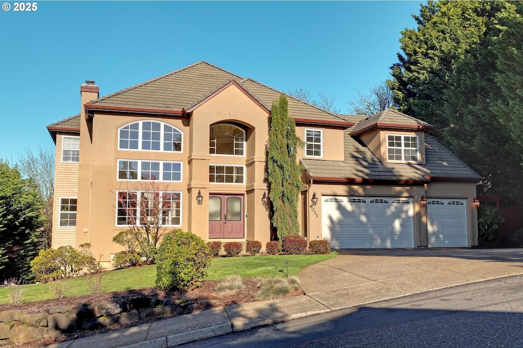 view of front of house with a front lawn and a garage