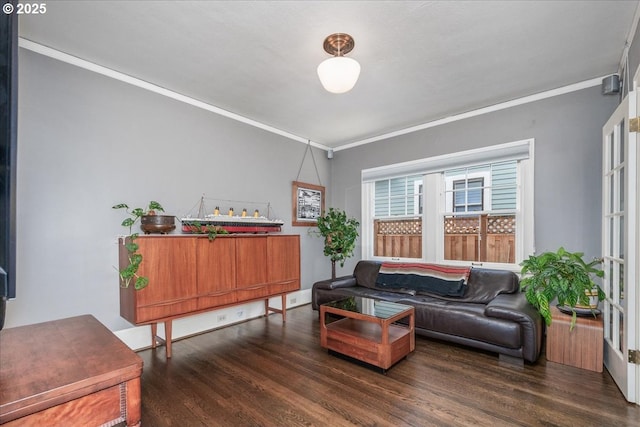 living room featuring ornamental molding and wood finished floors