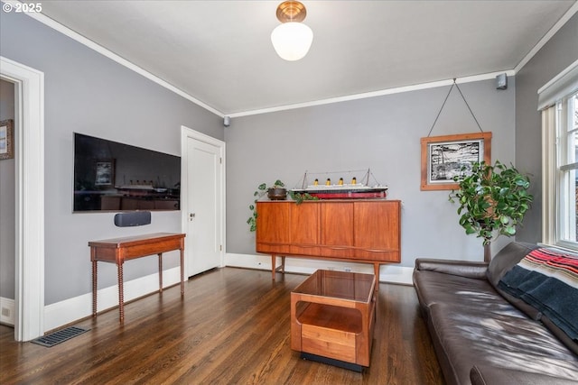 living area featuring dark wood-style floors, visible vents, baseboards, and ornamental molding